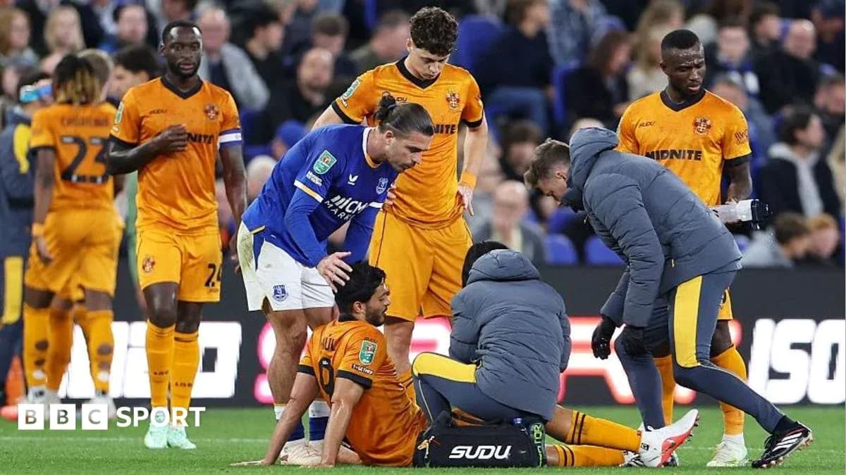 Players and medical staff attending to injured player Players and medical staff attending to injured player