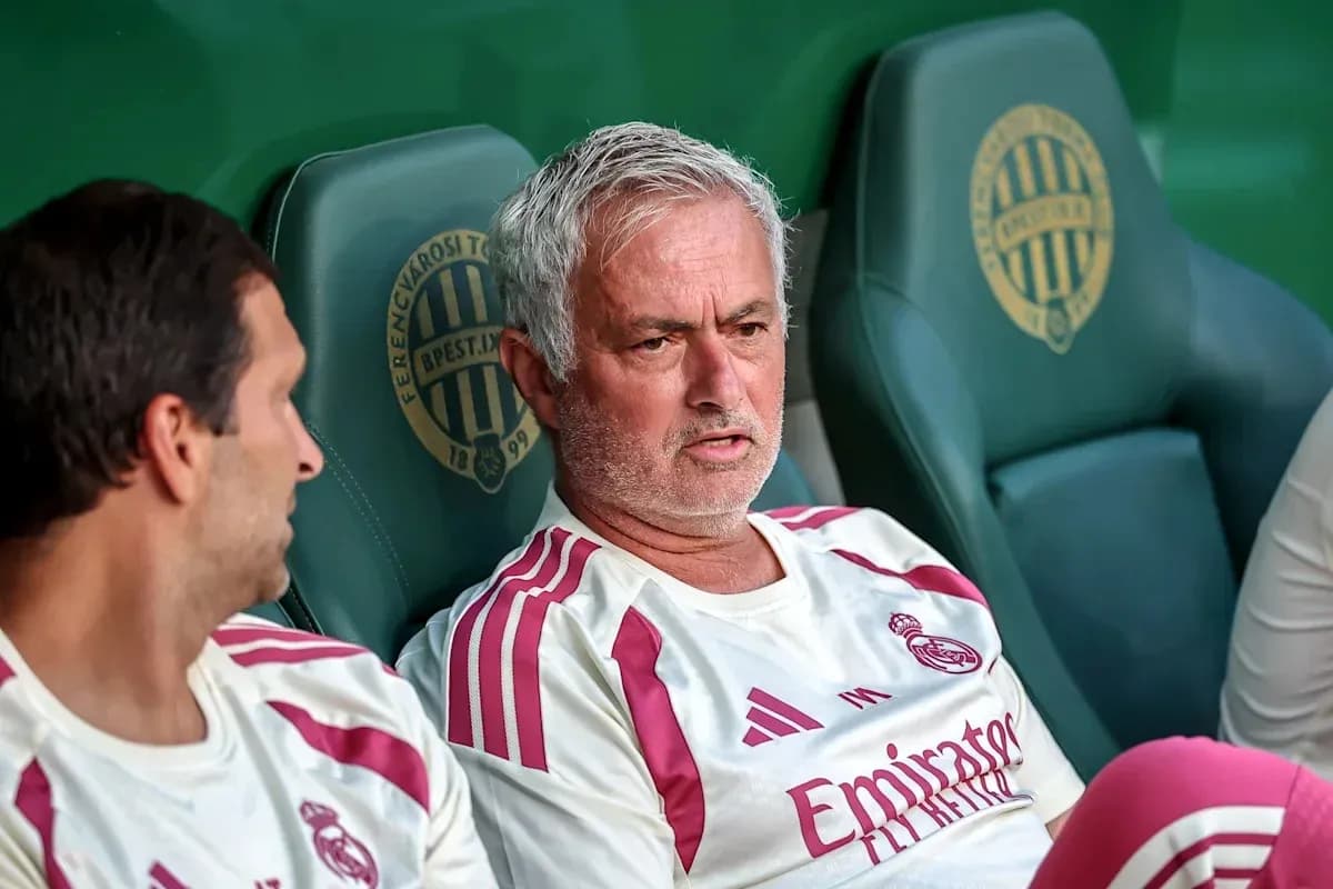 Two coaches seated on team bench during match Two coaches seated on team bench during match