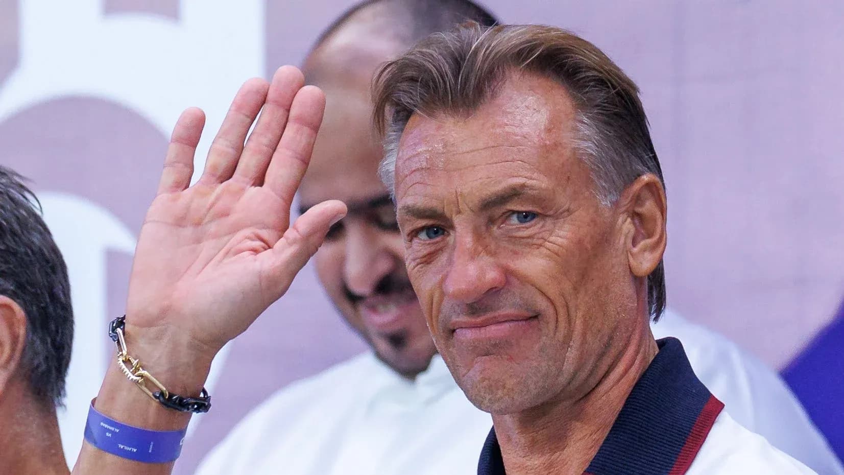 Coach waving during an event appearance Coach waving during an event appearance