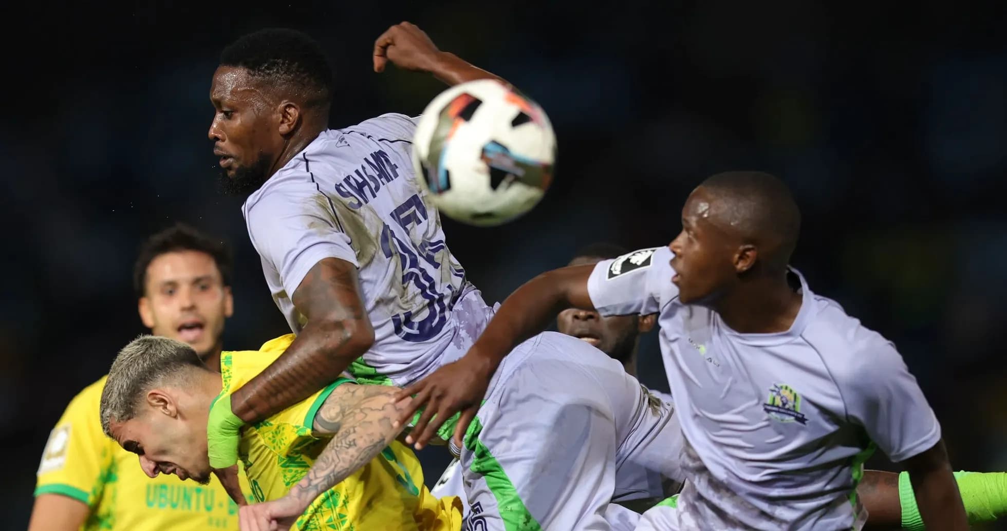 Players contesting for the ball during match action Players contesting for the ball during match action