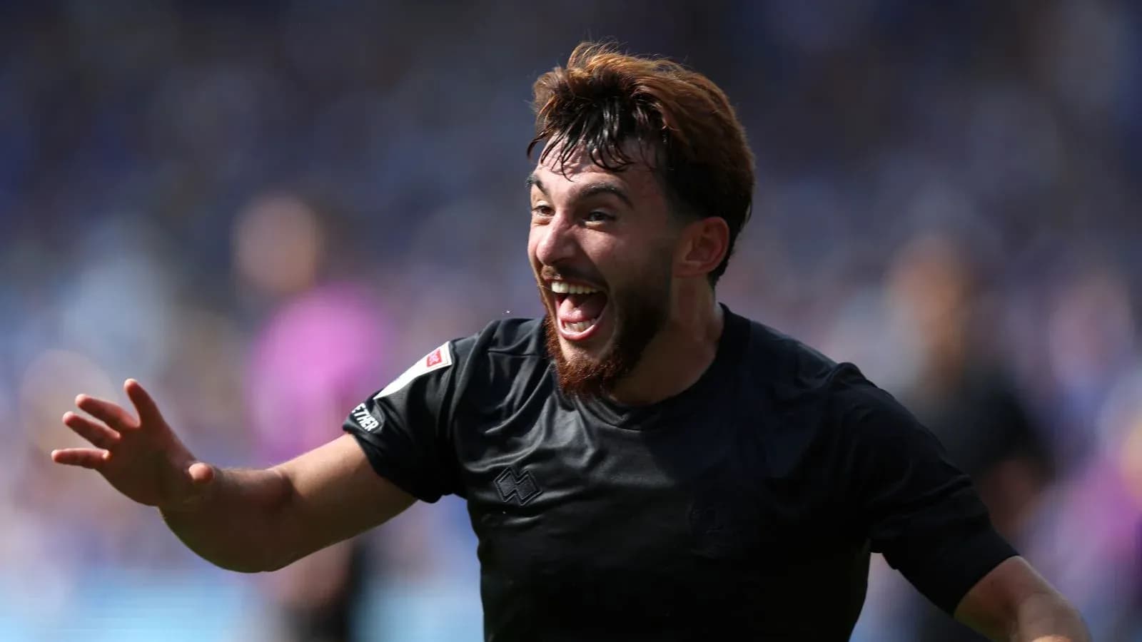 Player celebrating a goal with outstretched hand Player celebrating a goal with outstretched hand
