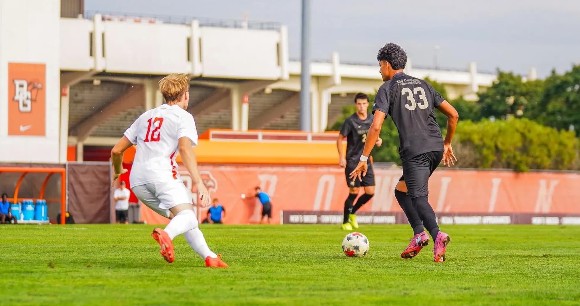 Player 12 chasing player 33 with soccer ball Player 12 chasing player 33 with soccer ball