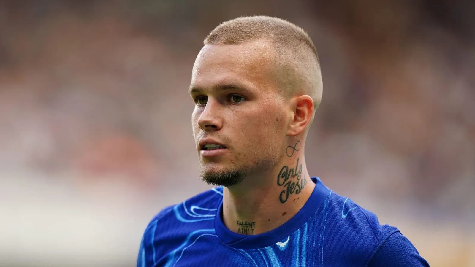 Player with tattoos wearing blue training shirt Player with tattoos wearing blue training shirt