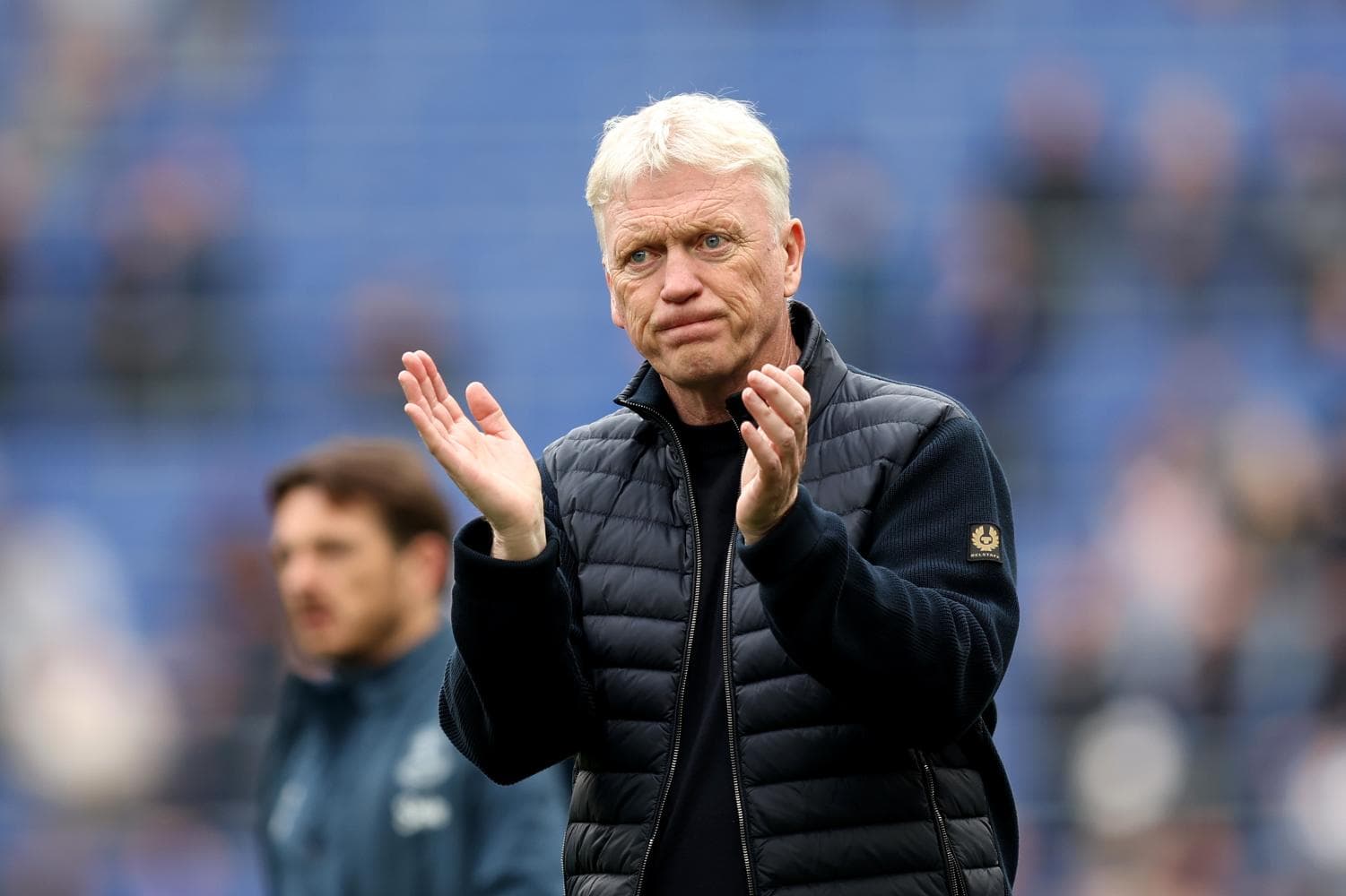 Manager applauding during a match on the sidelines Manager applauding during a match on the sidelines