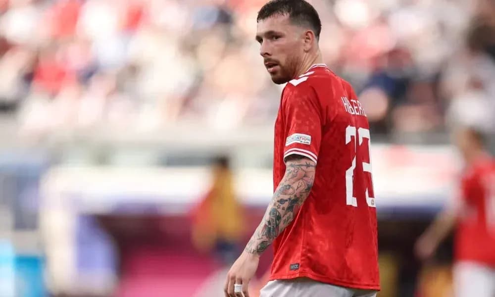 Player in red jersey during football match Player in red jersey during football match