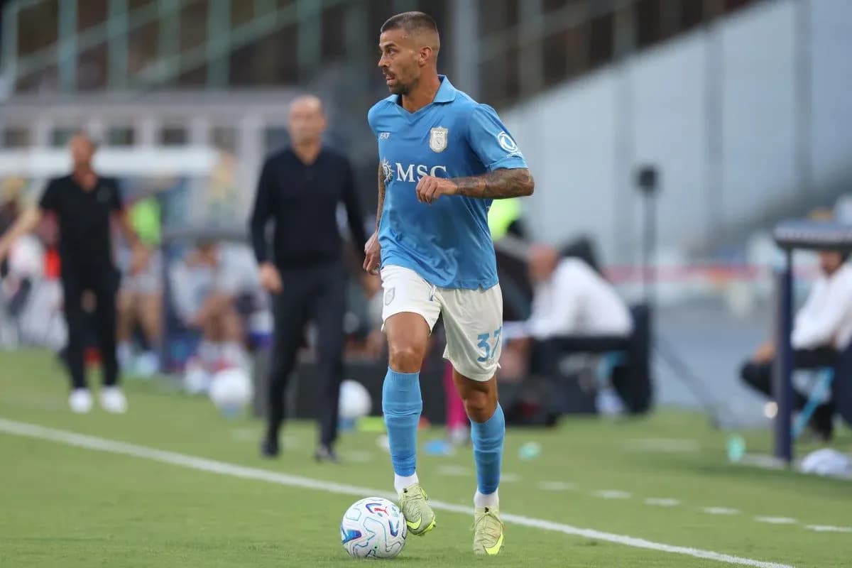 Player in blue kit dribbling the ball on field Player in blue kit dribbling the ball on field