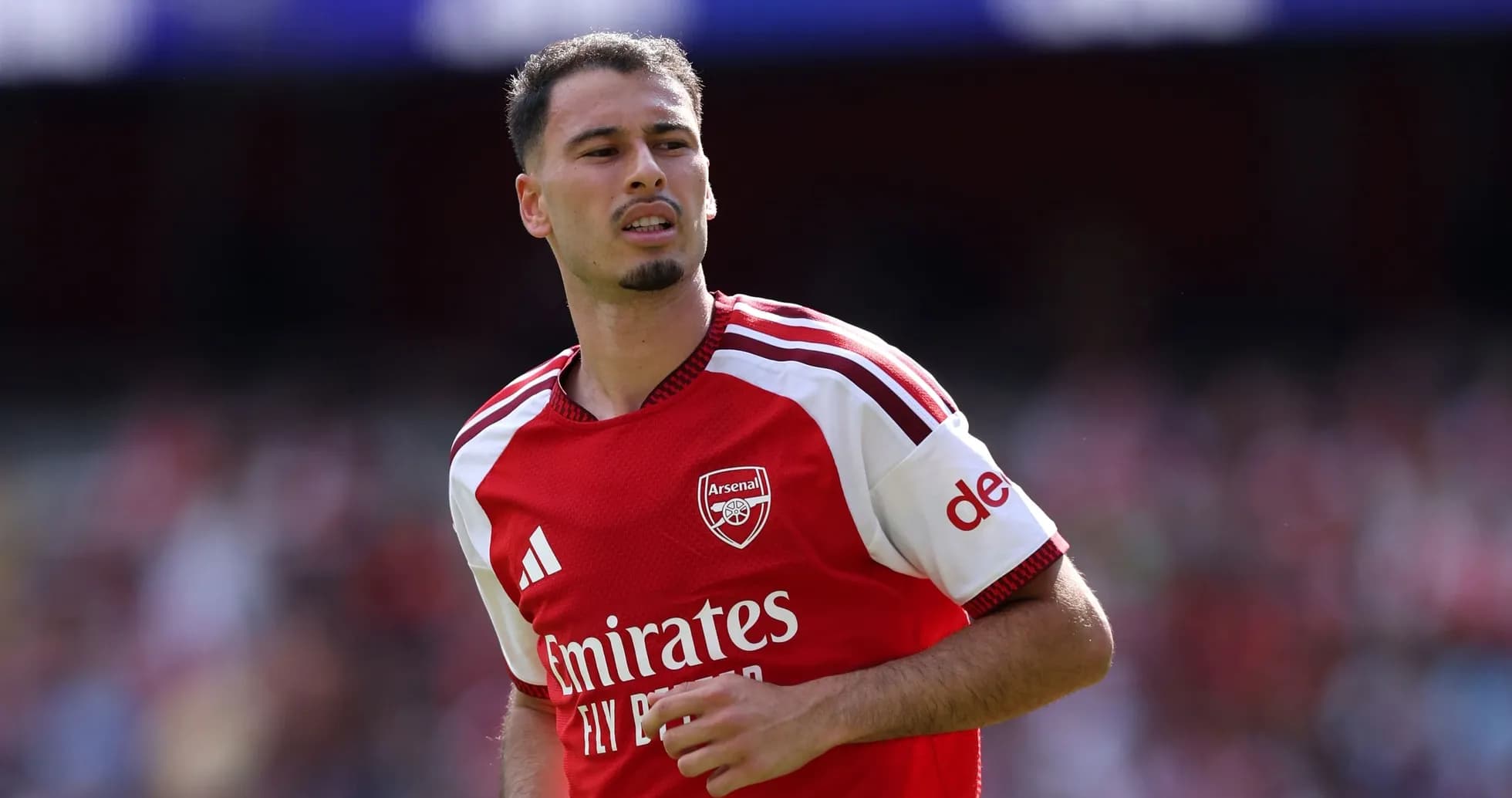 Arsenal player in red kit during match Arsenal player in red kit during match