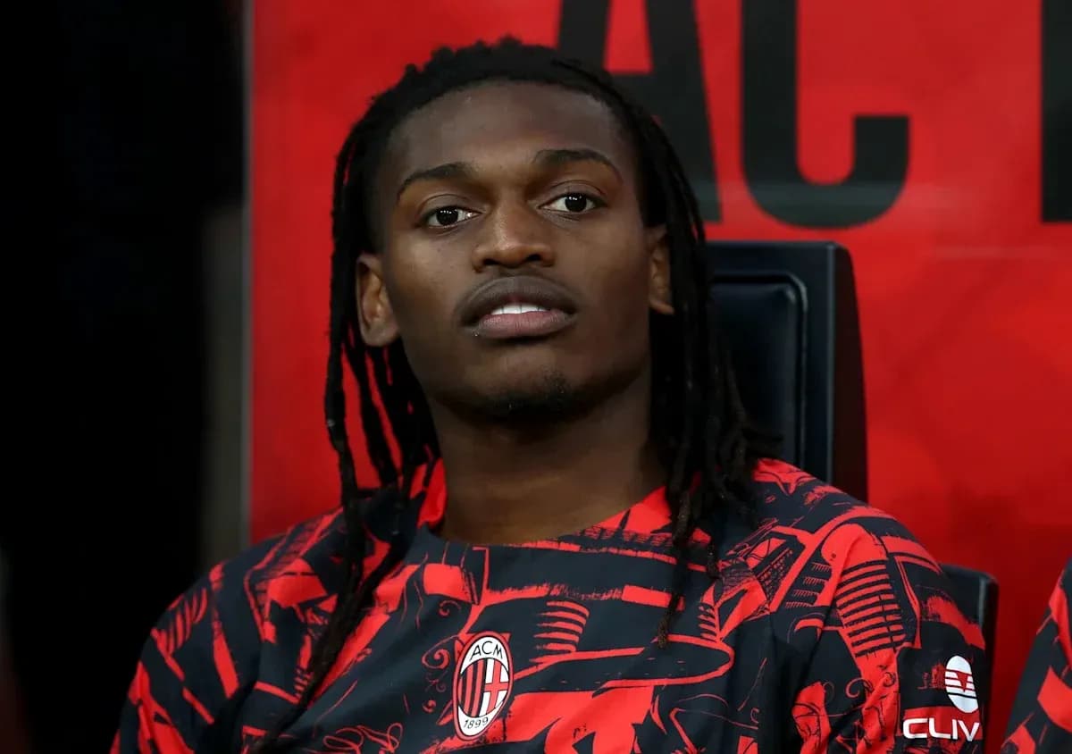 Player seated on bench wearing AC Milan jersey Player seated on bench wearing AC Milan jersey