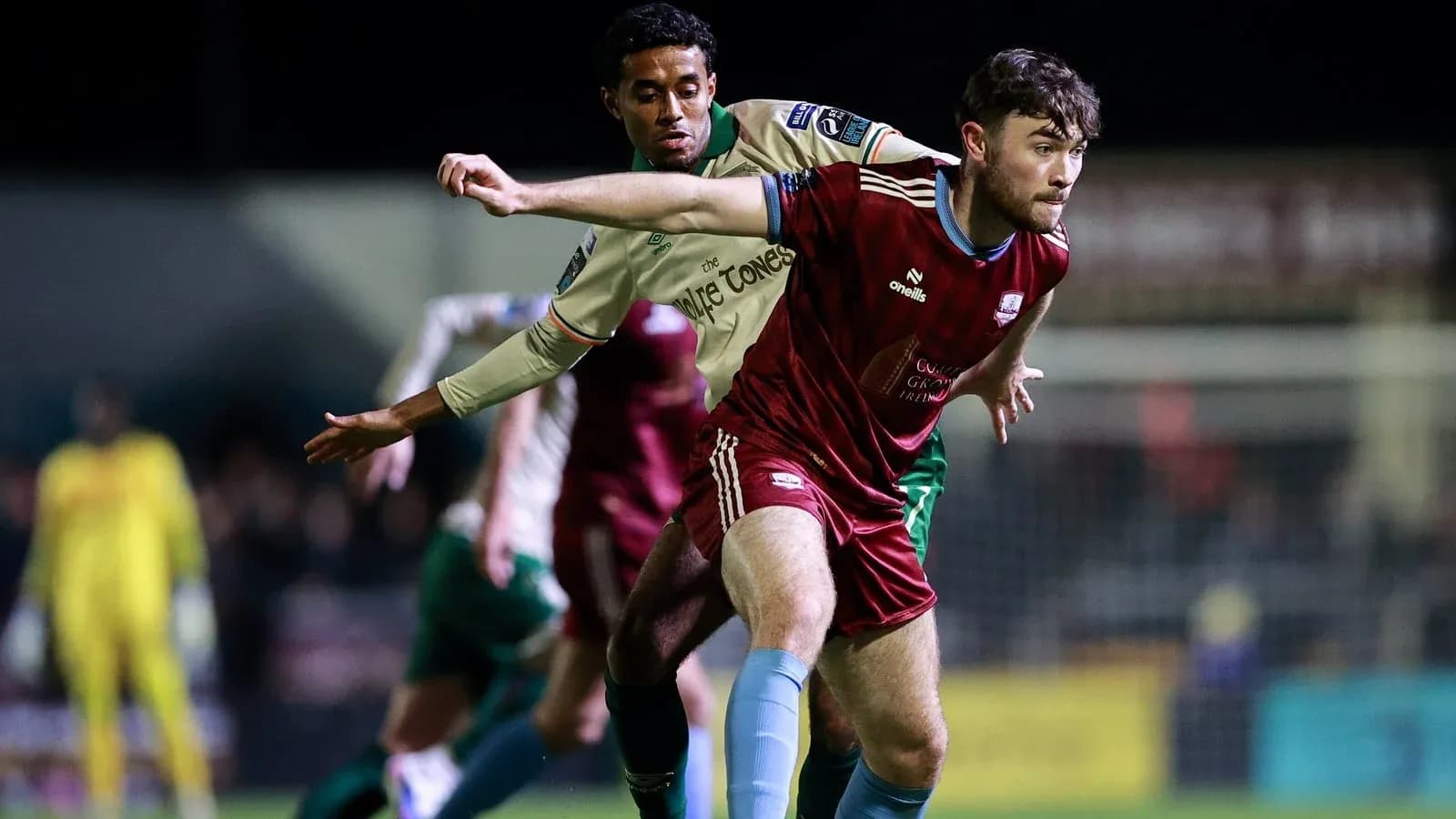Two players contesting possession during a football match Two players contesting possession during a football match
