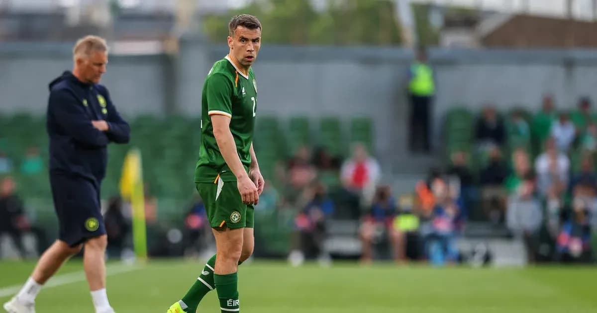 Irish player on field during match with coach nearby Irish player on field during match with coach nearby