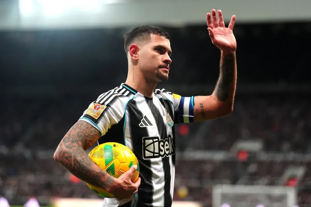 Player waving while holding a football during match Player waving while holding a football during match
