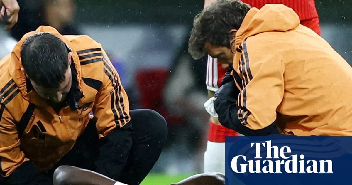 Medical staff attending to injured player on field Medical staff attending to injured player on field