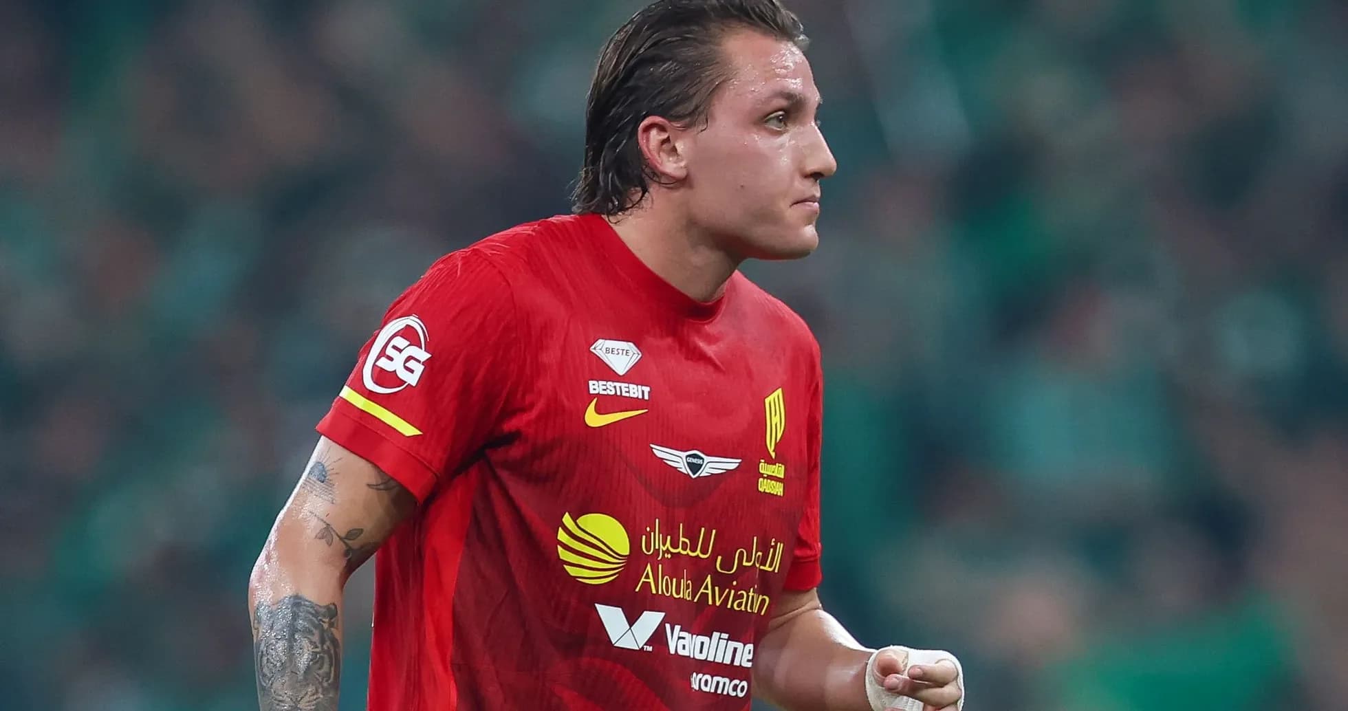 Player in red jersey during a match Player in red jersey during a match