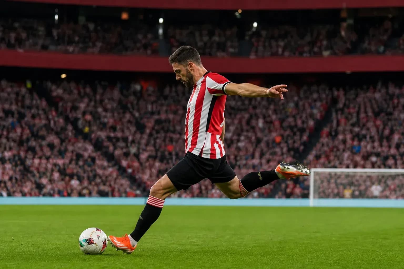 Player taking a free kick on the pitch Player taking a free kick on the pitch