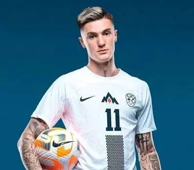 Player in white jersey holding soccer ball Player in white jersey holding soccer ball