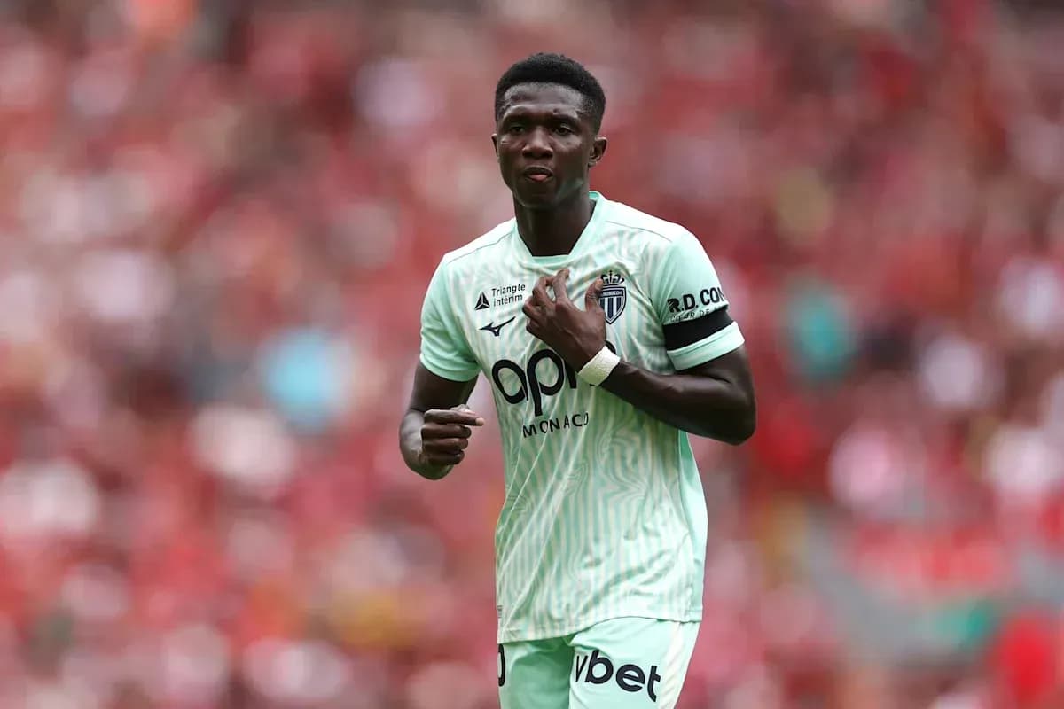 Player in green jersey during match at stadium Player in green jersey during match at stadium