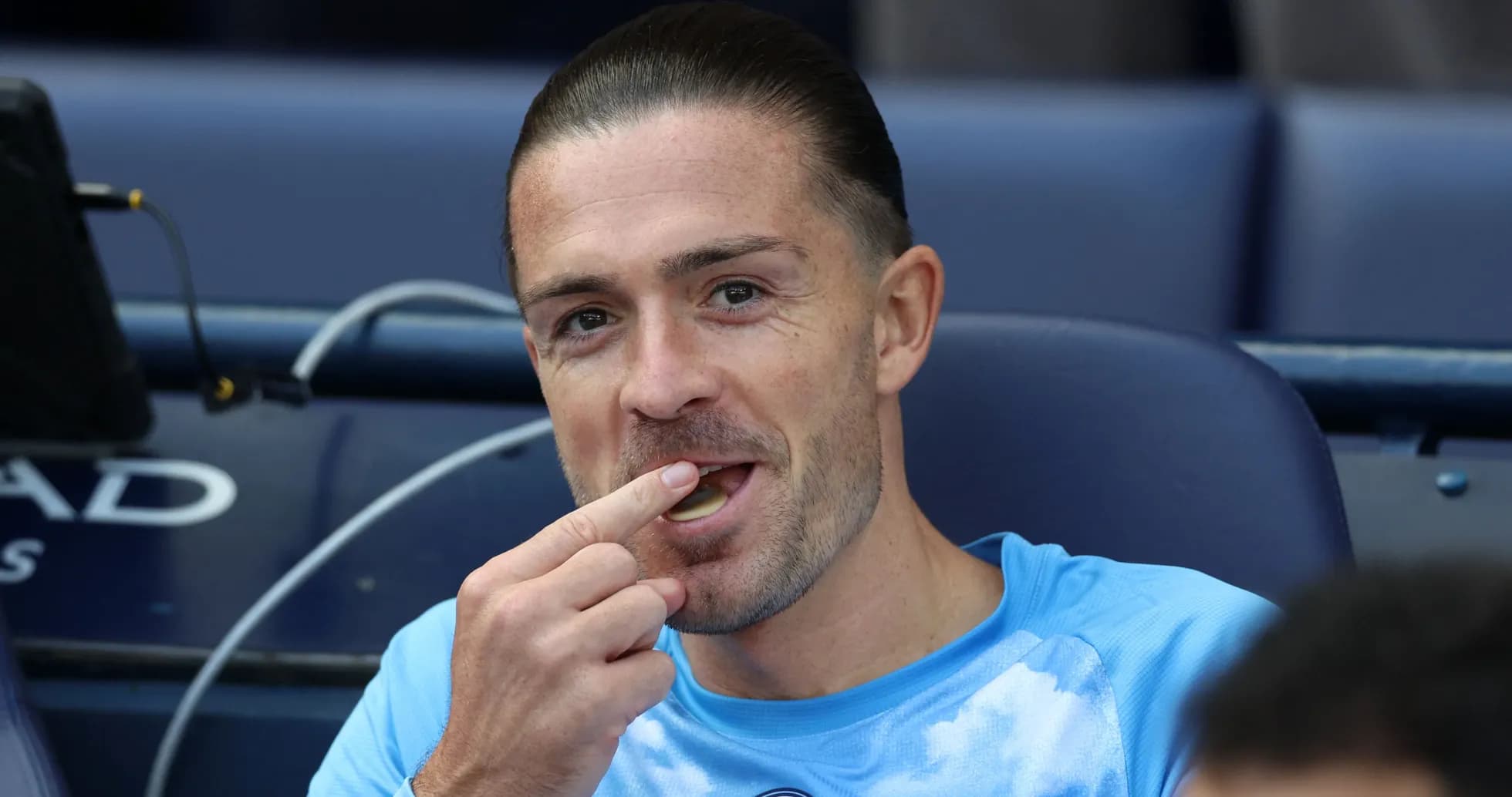 Player seated on bench, eating during match Player seated on bench, eating during match