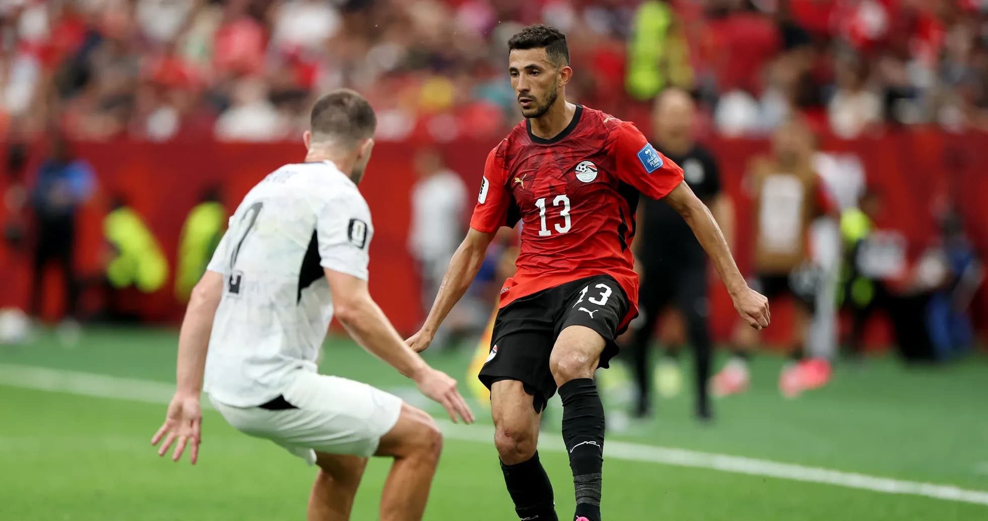 Egyptian player dribbling past opponent during match Egyptian player dribbling past opponent during match