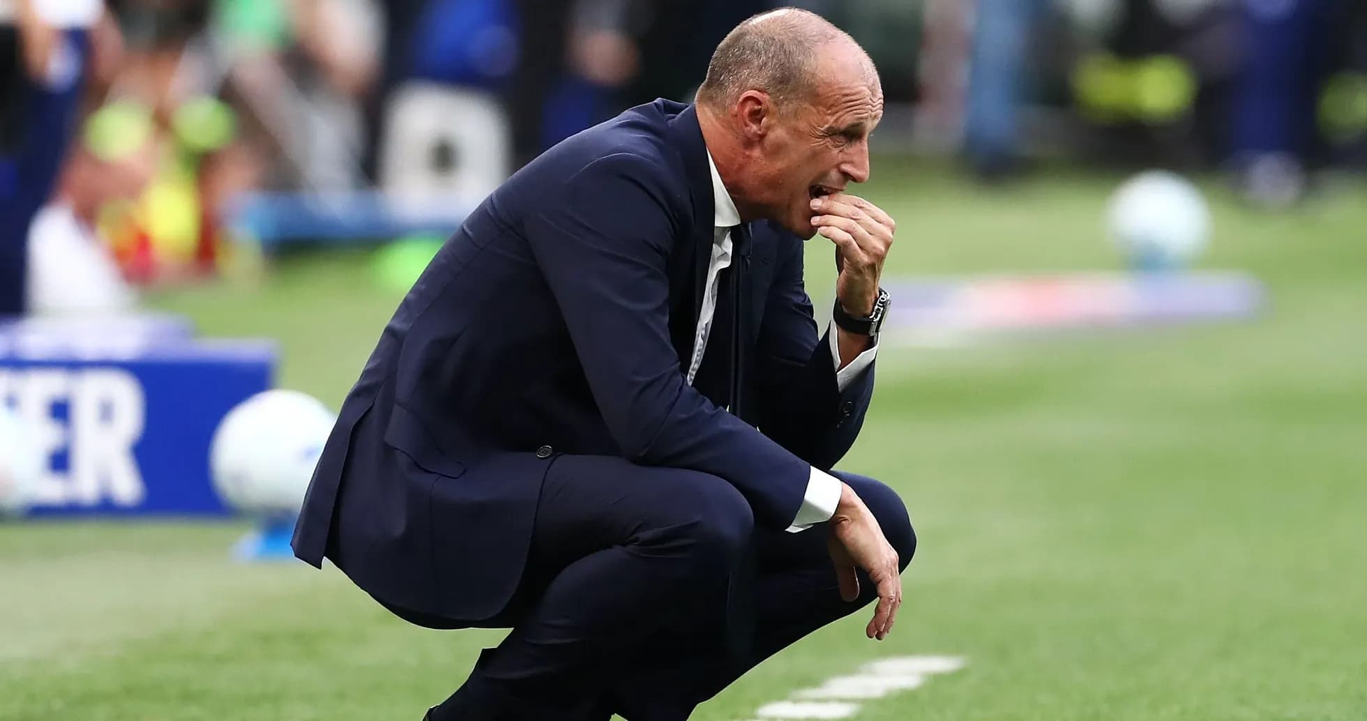 Coach crouching on sidelines during match Coach crouching on sidelines during match