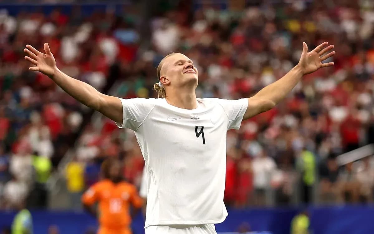 Player celebrating with arms raised during match Player celebrating with arms raised during match