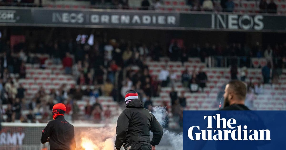 Fans lighting flares during a football match Fans lighting flares during a football match