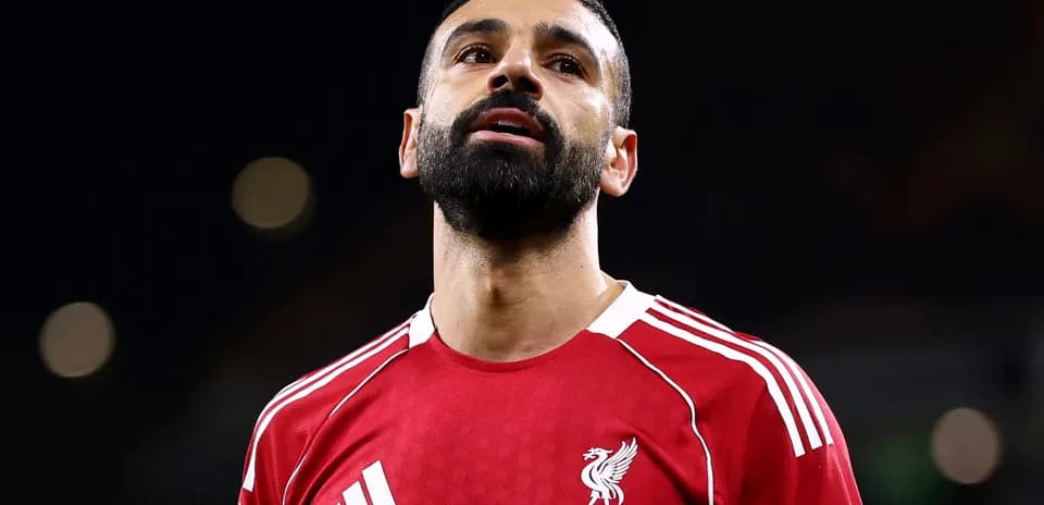 Player in red Liverpool jersey looking upwards Player in red Liverpool jersey looking upwards