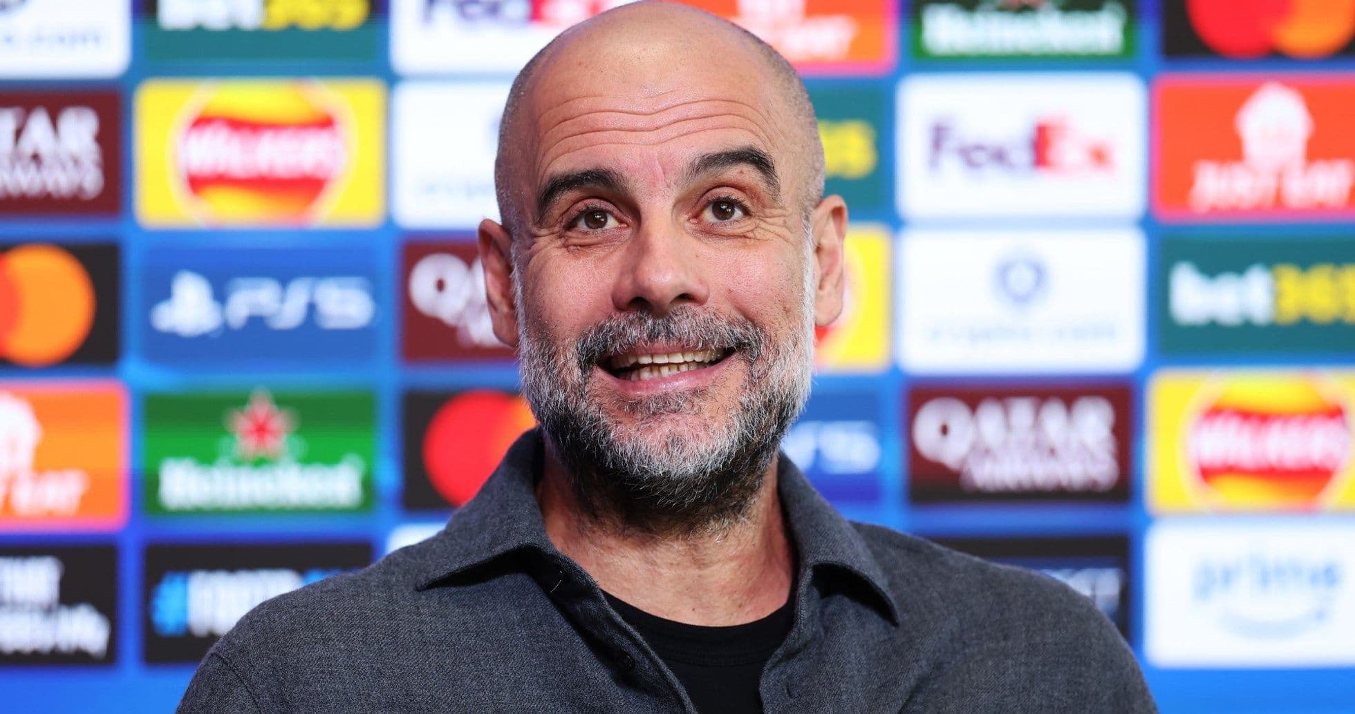 Manager speaking at press conference with sponsor backdrop Manager speaking at press conference with sponsor backdrop