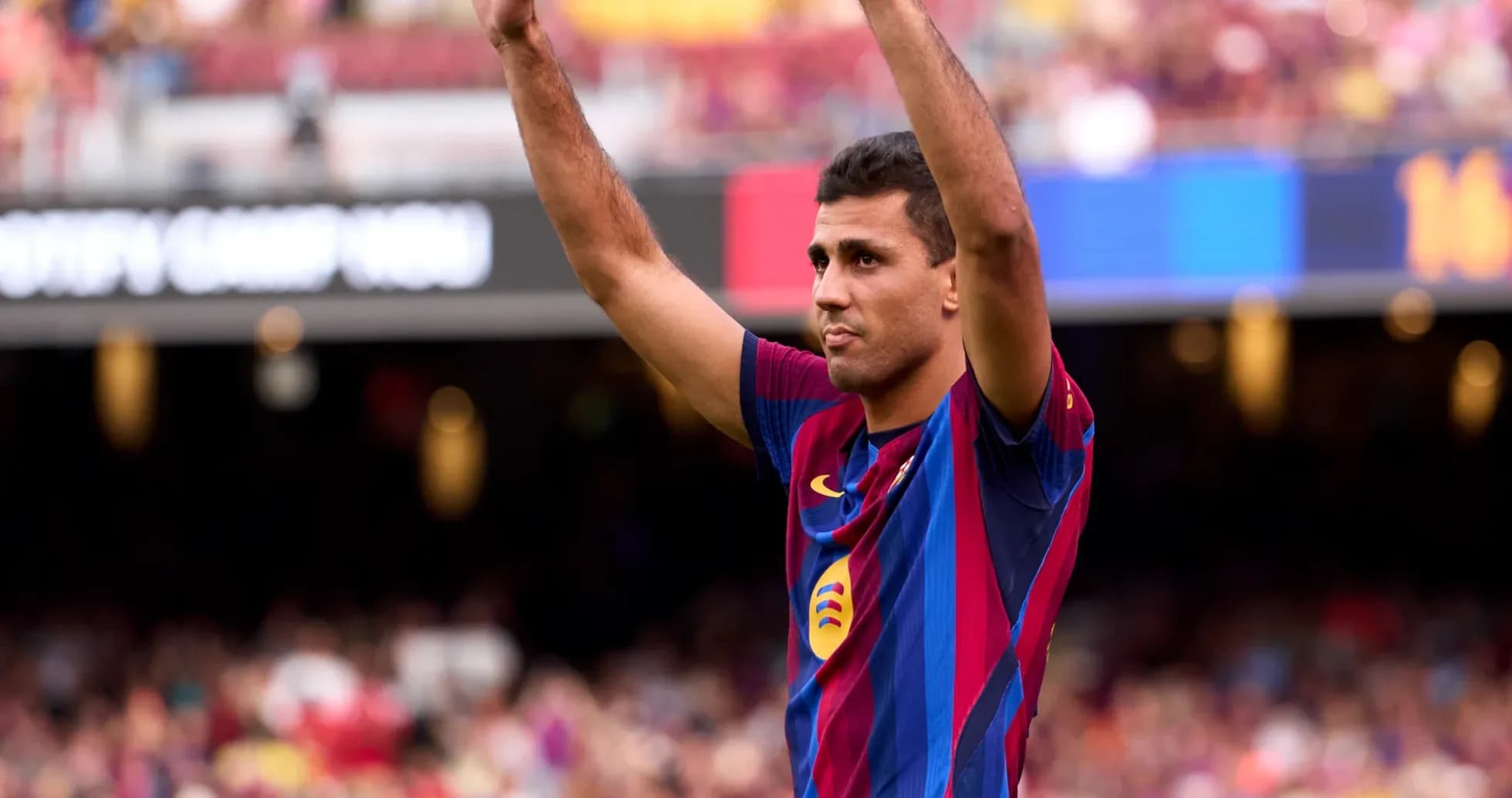 Player raising hands to fans at Camp Nou Player raising hands to fans at Camp Nou