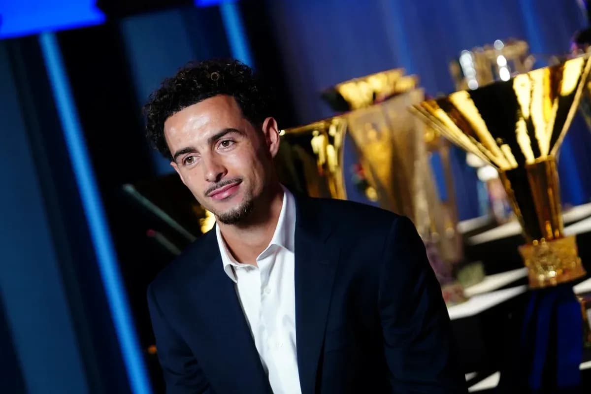 Player posing with trophies in the background Player posing with trophies in the background