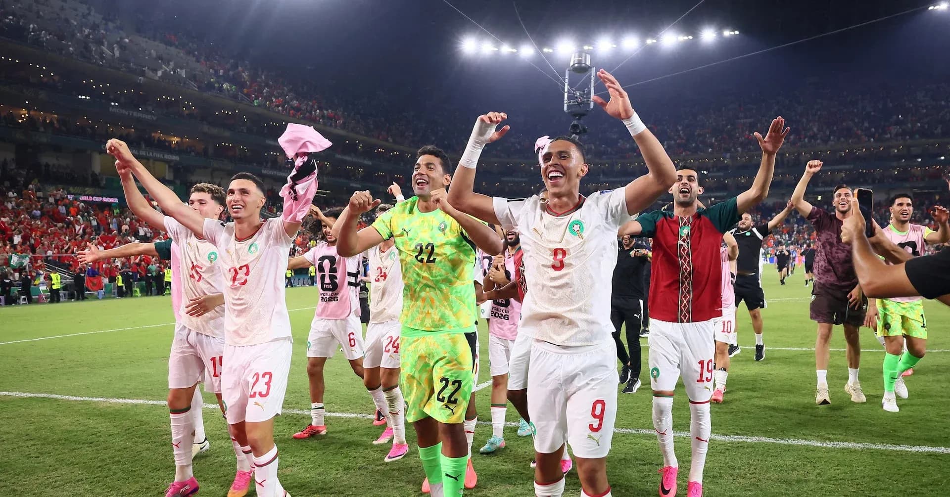 Morocco players celebrating victory at World Cup Morocco players celebrating victory at World Cup