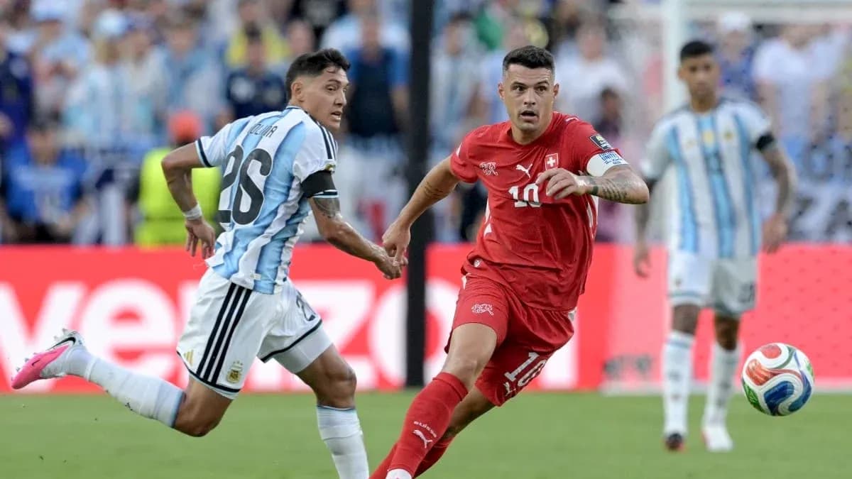 Argentinian player chasing Swiss player during match Argentinian player chasing Swiss player during match