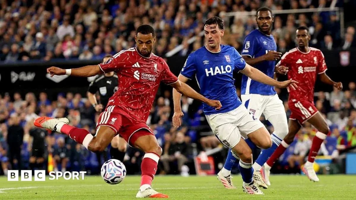 Liverpool player kicking the ball against Ipswich defenders Liverpool player kicking the ball against Ipswich defenders