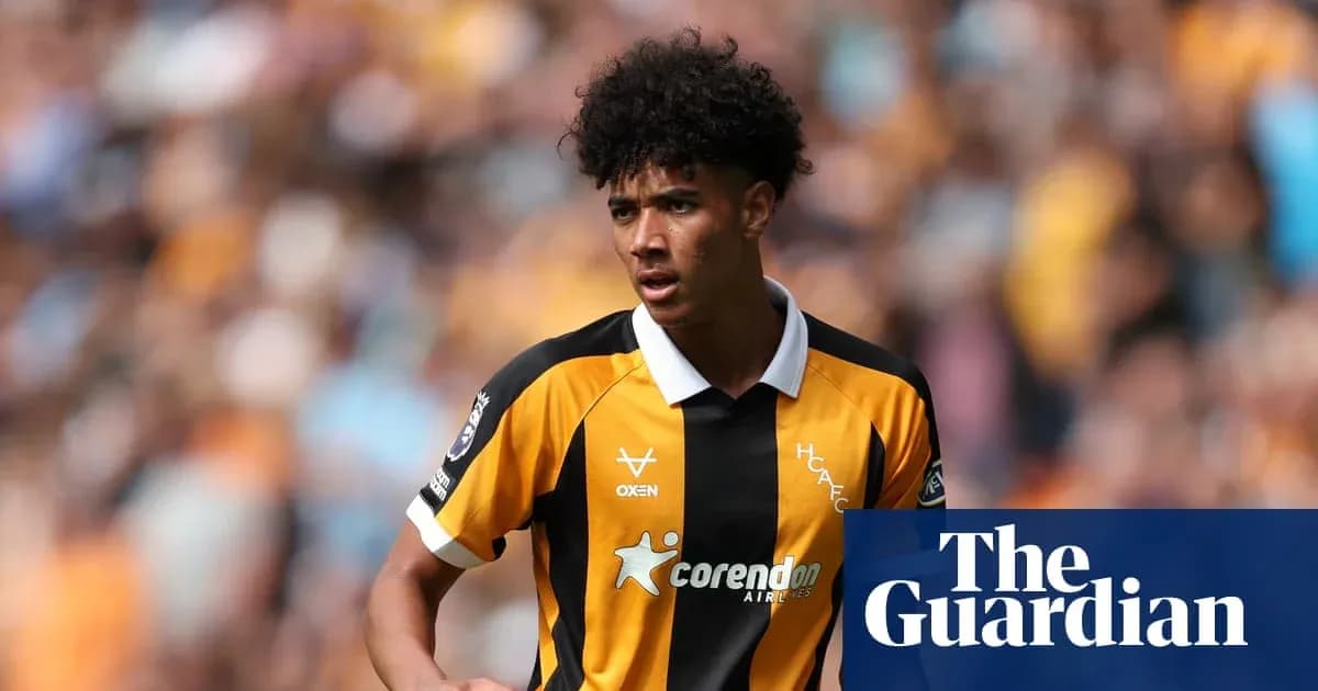 Player in striped yellow and black jersey on pitch Player in striped yellow and black jersey on pitch