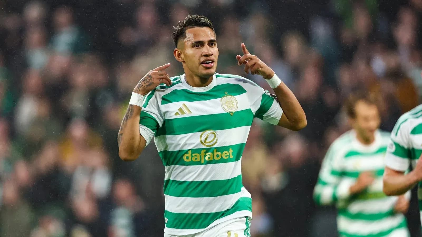Player celebrating goal in Celtic's green and white kit Player celebrating goal in Celtic's green and white kit