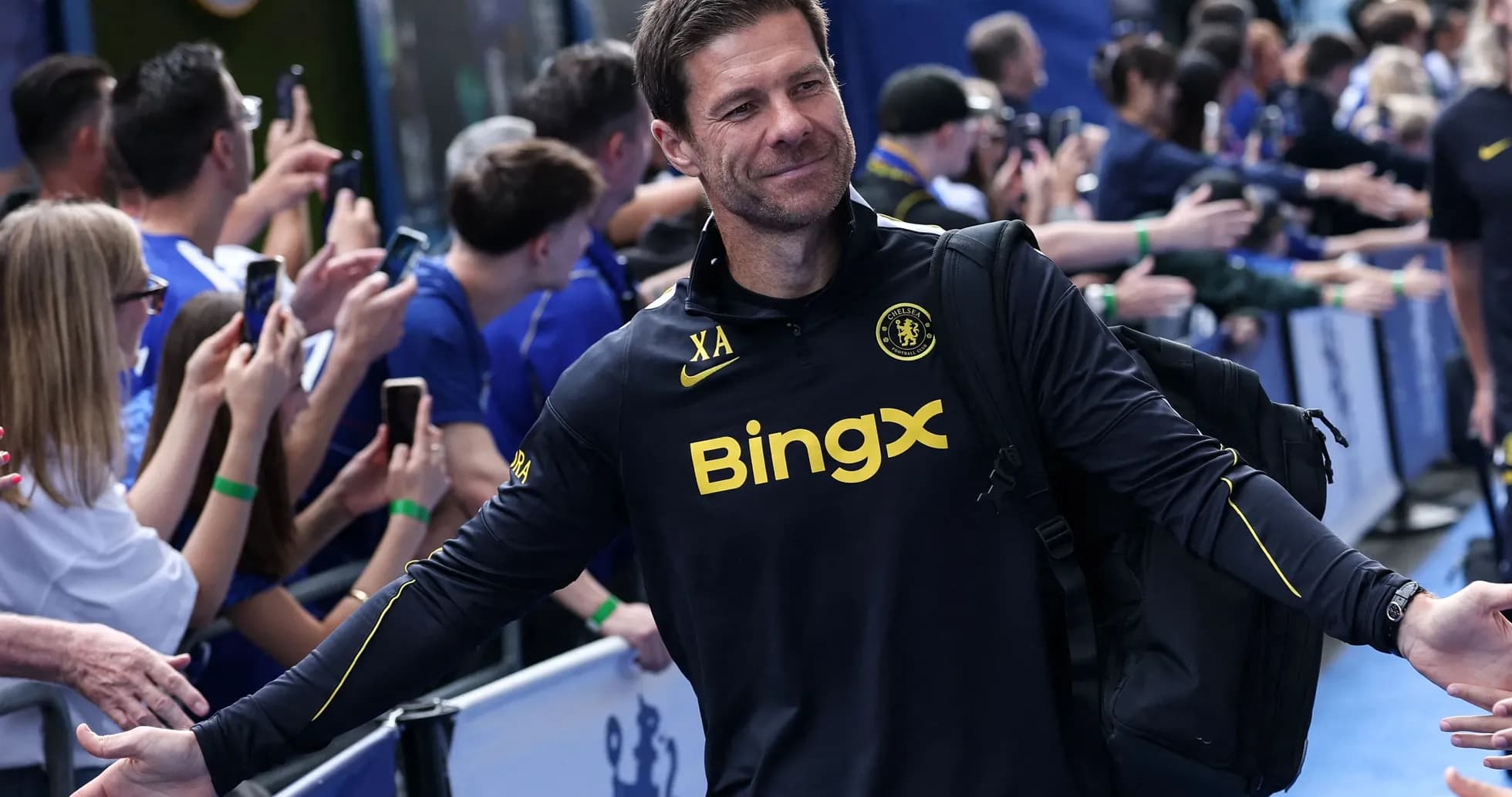 Coach greeting fans outside stadium before match Coach greeting fans outside stadium before match