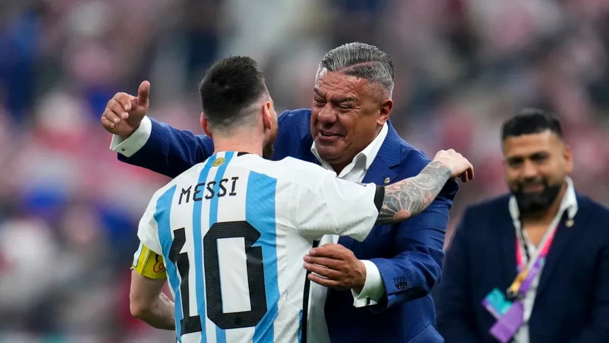Lionel Messi hugging a man in a suit Lionel Messi hugging a man in a suit