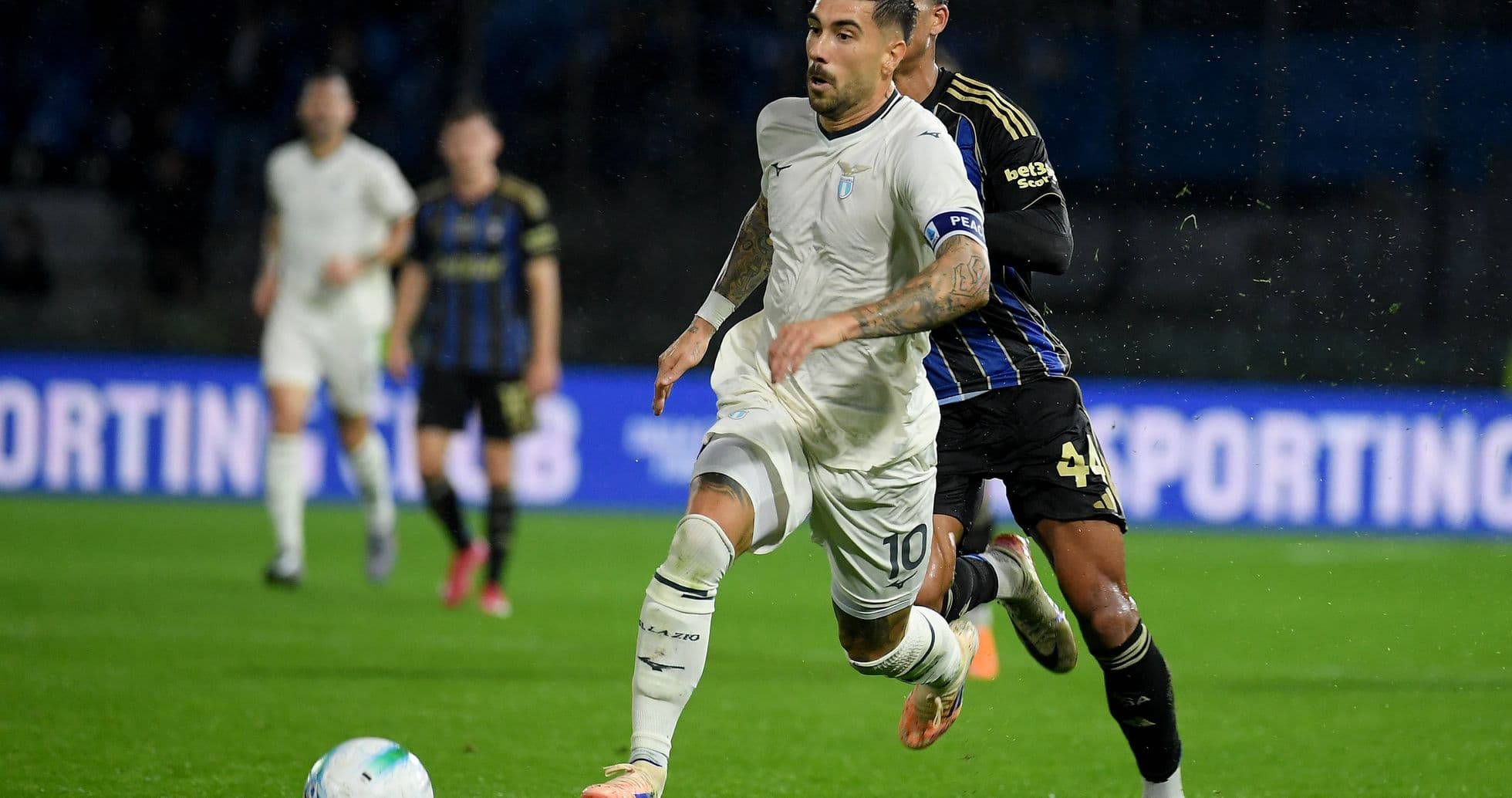 Lazio player dribbling past Pisa defender Lazio player dribbling past Pisa defender