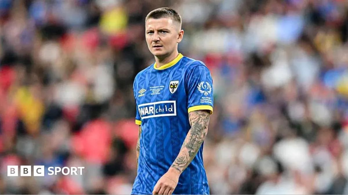 Player in blue kit on football field during match Player in blue kit on football field during match