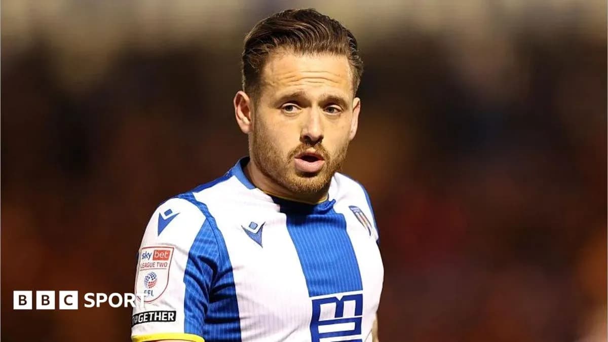 Player wearing blue and white kit on the field Player wearing blue and white kit on the field