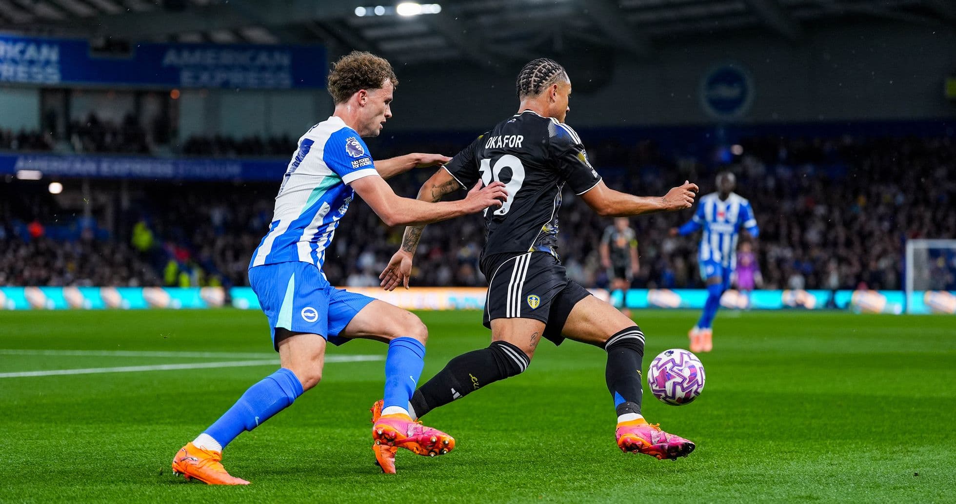 Leeds player being challenged by Brighton player Leeds player being challenged by Brighton player