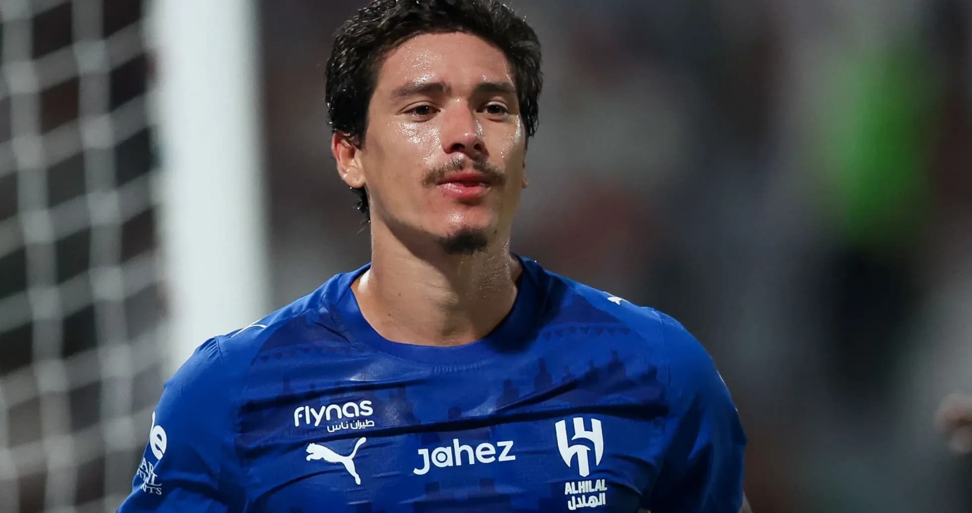 Player wearing blue jersey during a match Player wearing blue jersey during a match