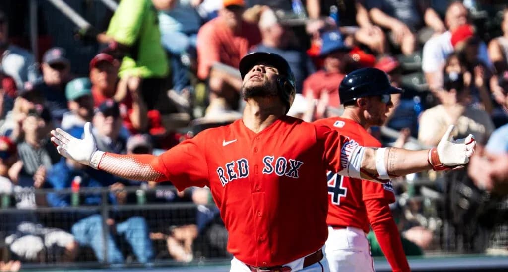 Red Sox player celebrating with fans in background Red Sox player celebrating with fans in background