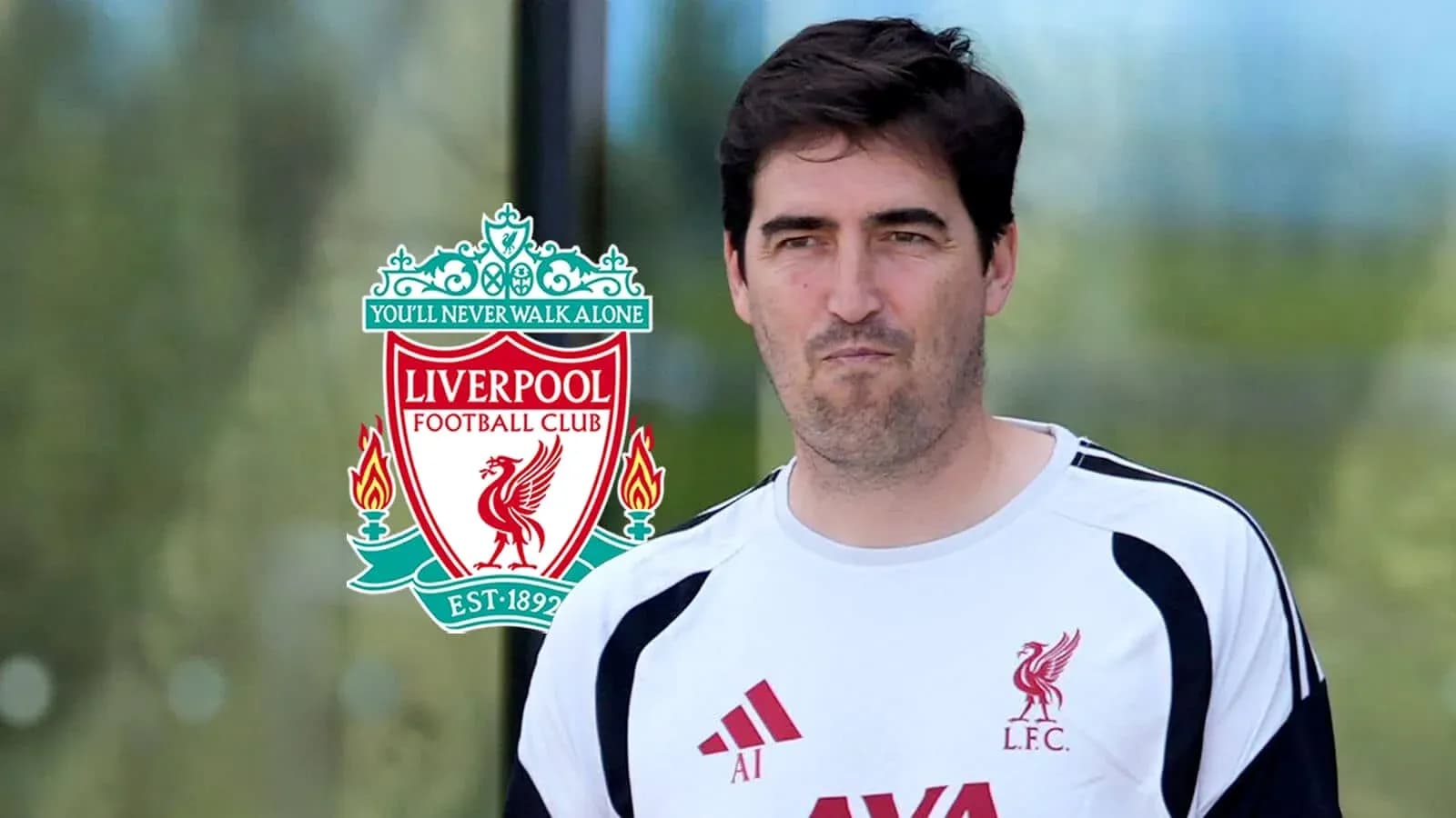 Coach walking past Liverpool FC logo outdoors Coach walking past Liverpool FC logo outdoors