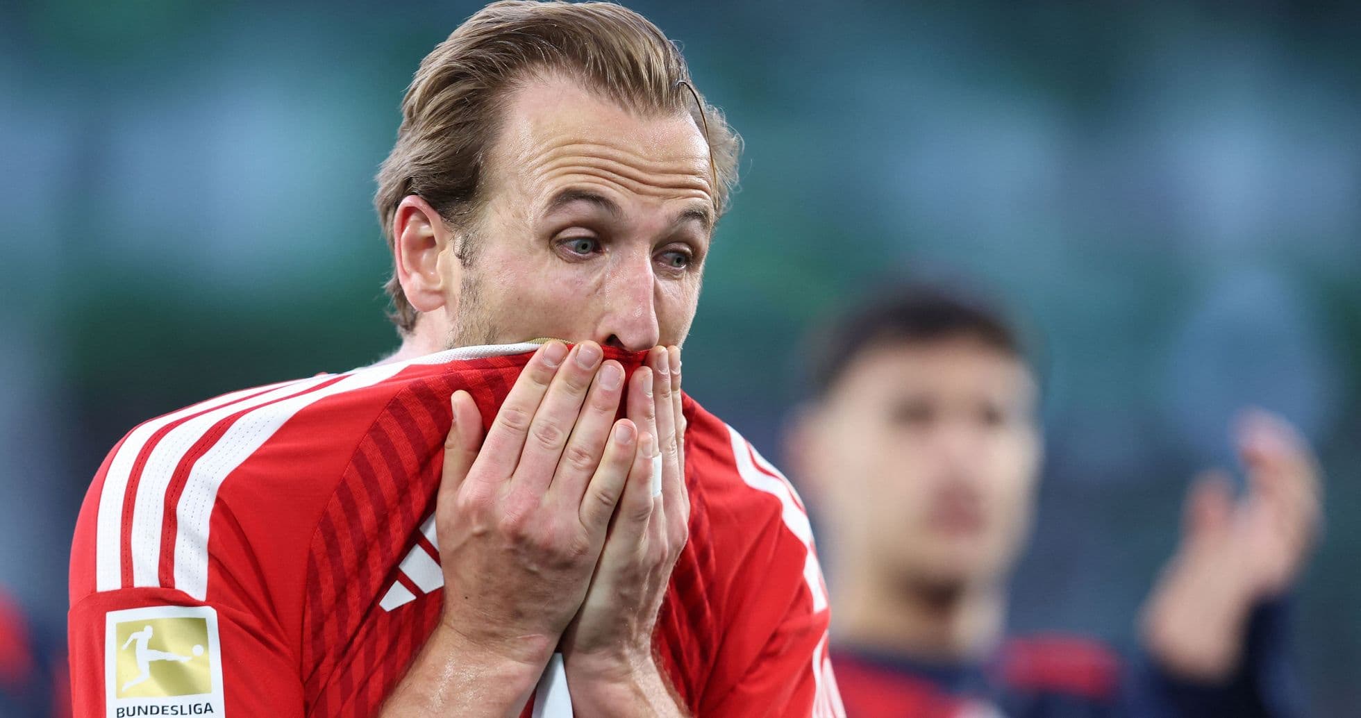 Player covering face with shirt after match Player covering face with shirt after match