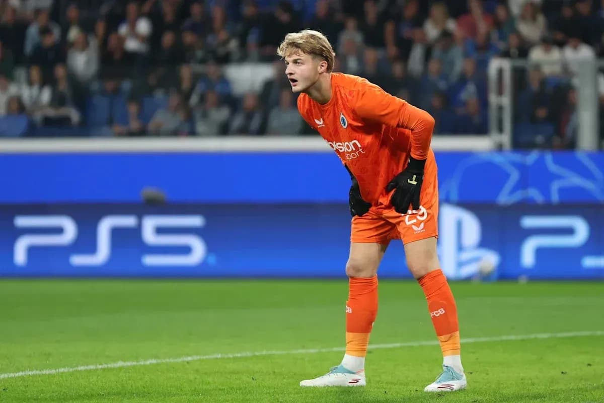 Goalkeeper in orange kit preparing for action Goalkeeper in orange kit preparing for action