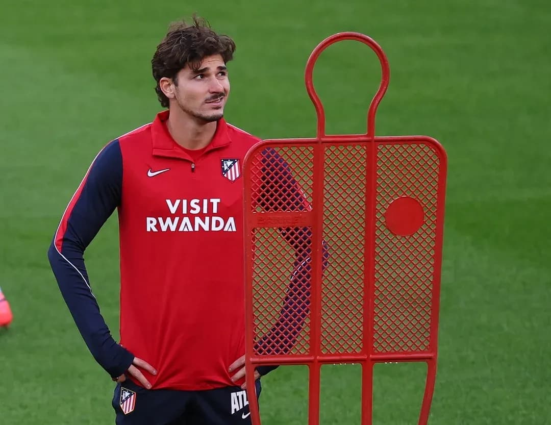 Player standing next to training dummy on pitch Player standing next to training dummy on pitch
