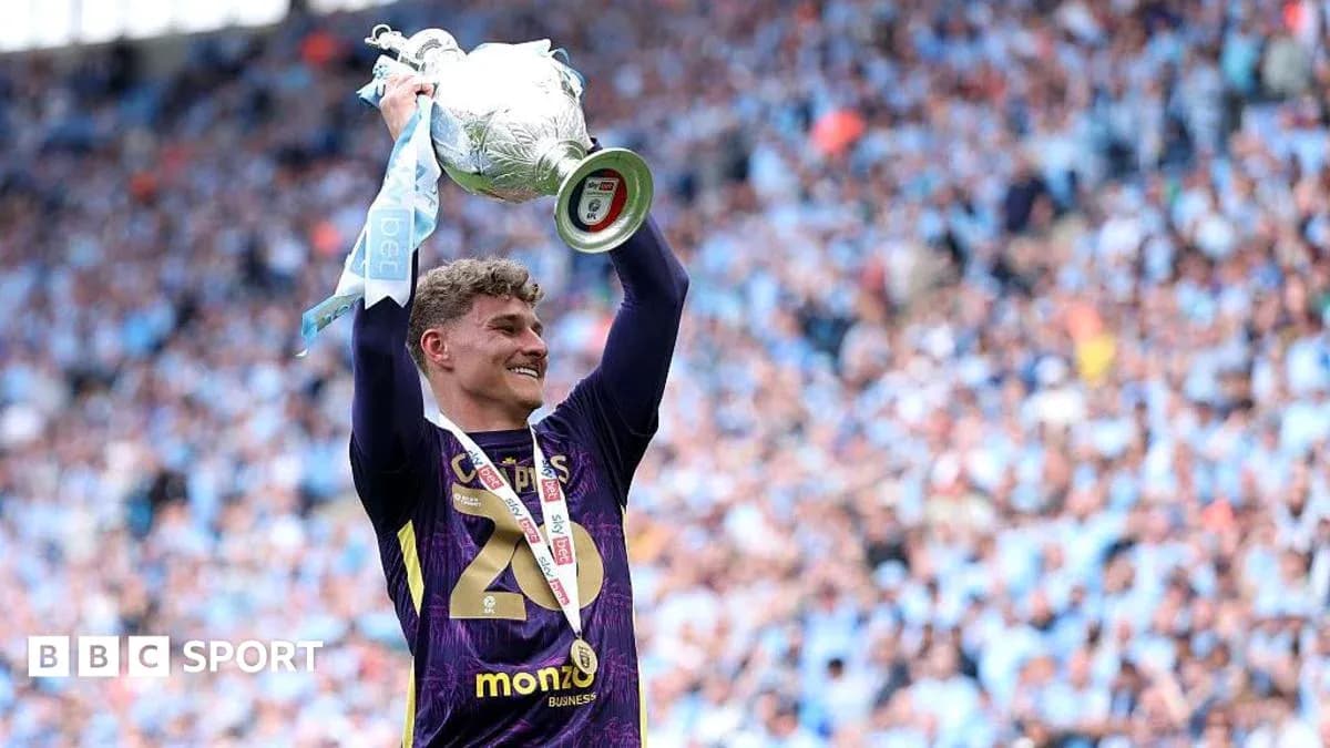 Goalkeeper celebrating with trophy after winning match Goalkeeper celebrating with trophy after winning match