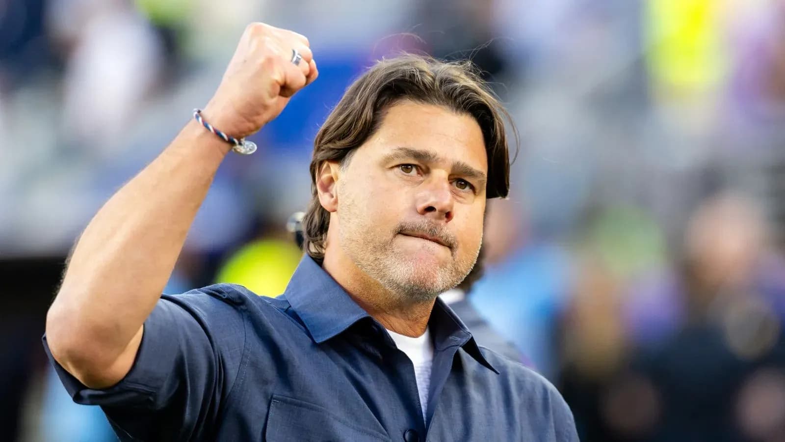 Coach celebrating with raised fist on sidelines Coach celebrating with raised fist on sidelines