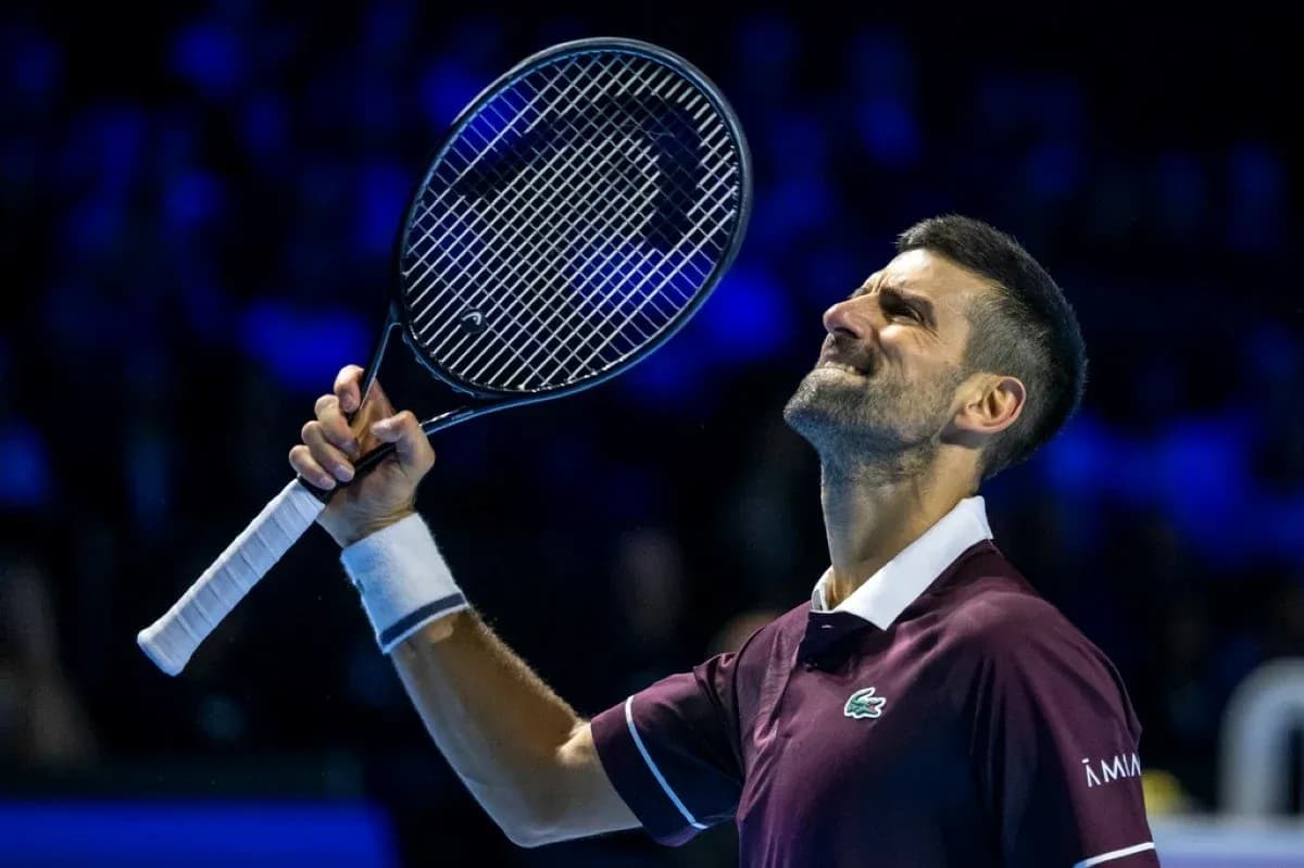 Tennis player celebrating with racket raised after victory Tennis player celebrating with racket raised after victory