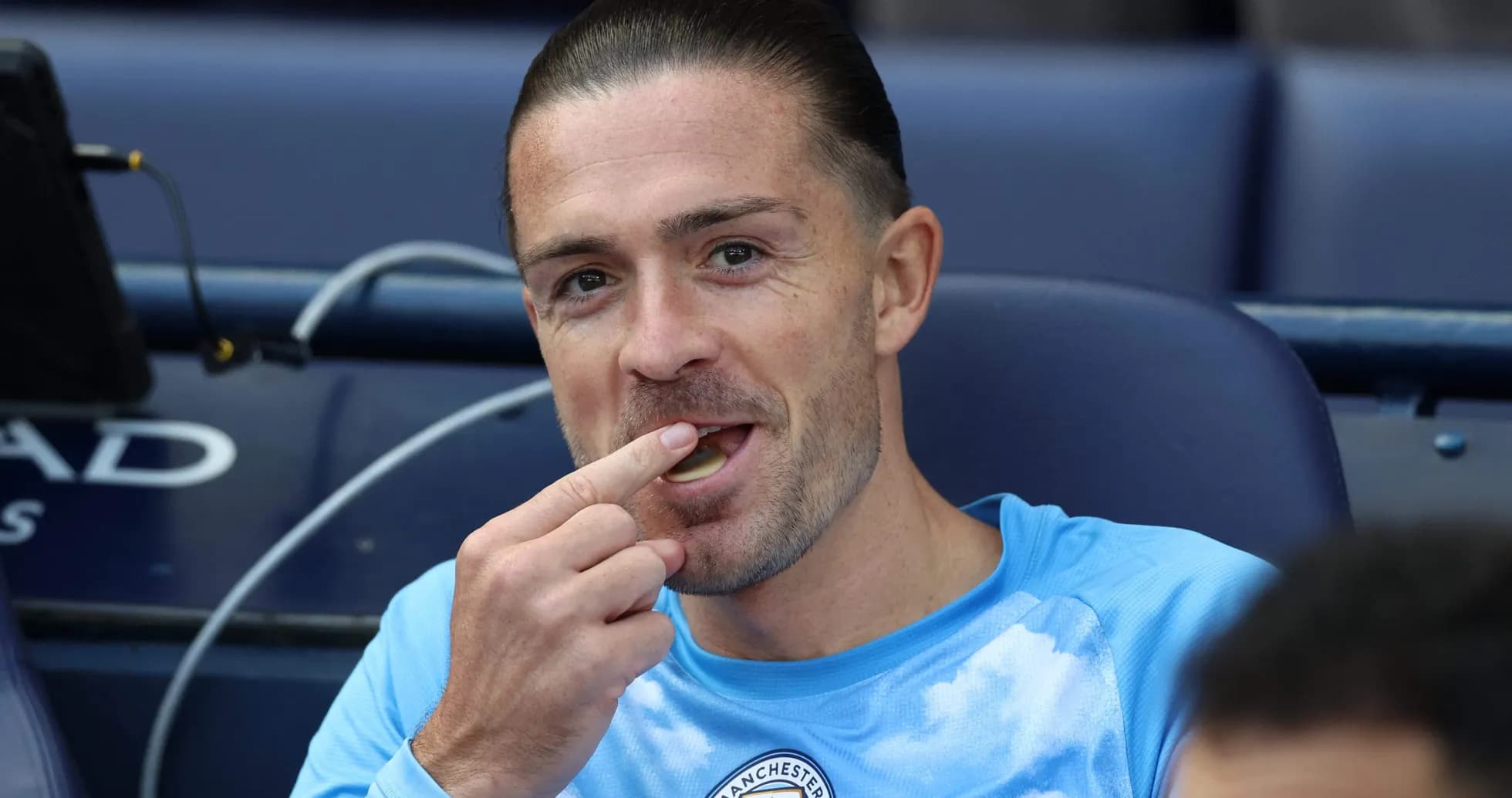 Player sitting on bench, eating snack during match Player sitting on bench, eating snack during match